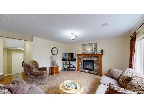 204 Westland Street, Okotoks, AB - Indoor Photo Showing Living Room With Fireplace