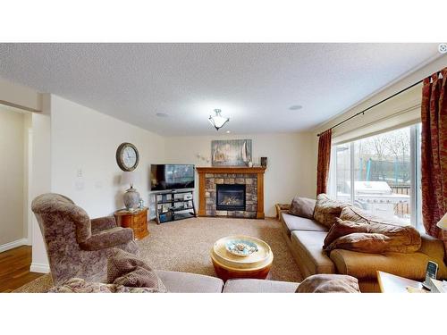 204 Westland Street, Okotoks, AB - Indoor Photo Showing Living Room With Fireplace