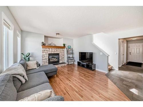 66 Prestwick Landing Se, Calgary, AB - Indoor Photo Showing Living Room With Fireplace