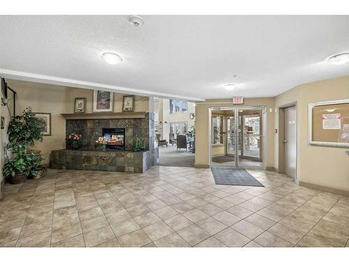 323-428 Chaparral Ravine View Se, Calgary, AB - Indoor With Fireplace