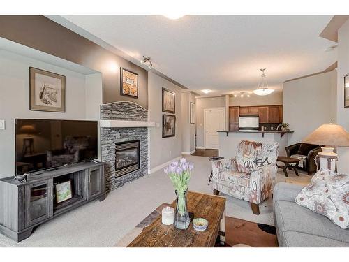437-20 Discovery Ridge Close Sw, Calgary, AB - Indoor Photo Showing Living Room With Fireplace