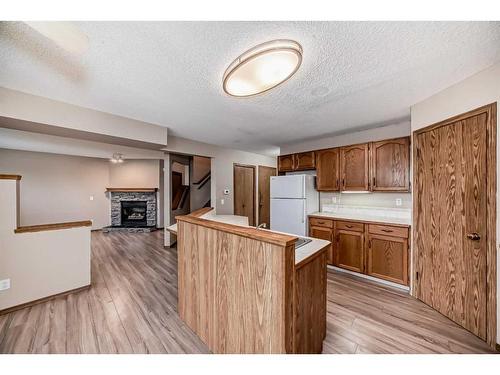 118 Somercrest Gardens Sw, Calgary, AB - Indoor Photo Showing Kitchen With Fireplace