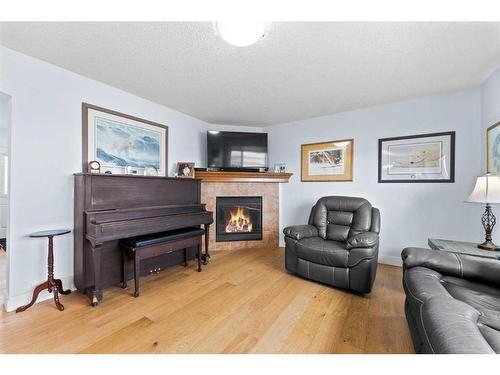 561 Diamond Crescent, Diamond Valley, AB - Indoor Photo Showing Living Room With Fireplace
