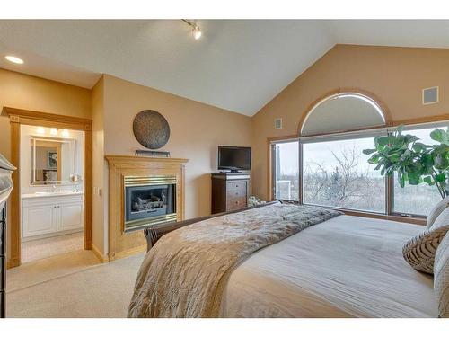 531 Hawkside Mews Nw, Calgary, AB - Indoor Photo Showing Bedroom With Fireplace