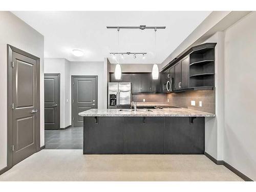 2405-310 Mckenzie Towne Gate Se, Calgary, AB - Indoor Photo Showing Kitchen With Double Sink