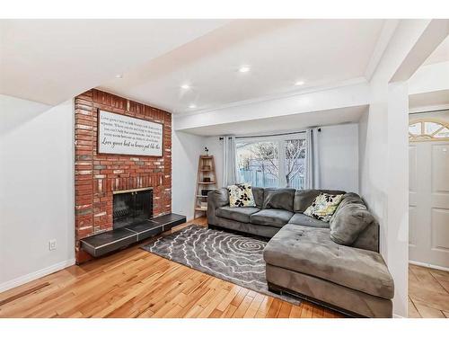 19 Mckernan Road Se, Calgary, AB - Indoor Photo Showing Living Room With Fireplace