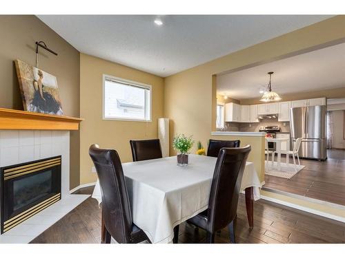 54 Arbour Crest Circle Nw, Calgary, AB - Indoor Photo Showing Dining Room With Fireplace