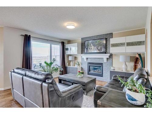 26 Hidden Ridge Close Nw, Calgary, AB - Indoor Photo Showing Living Room With Fireplace