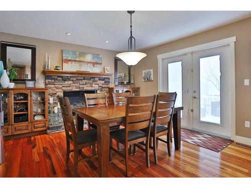 148 Hidden Circle Nw, Calgary, AB - Indoor Photo Showing Dining Room With Fireplace