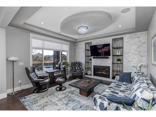 168 Kinniburgh Loop, Chestermere, AB - Indoor Photo Showing Living Room With Fireplace