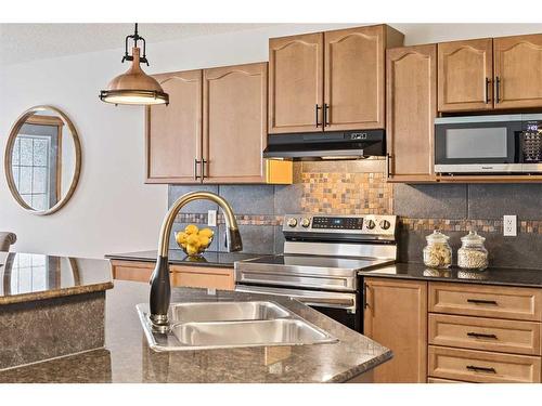513 Coopers Drive Sw, Airdrie, AB - Indoor Photo Showing Kitchen With Double Sink