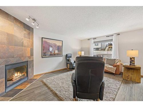 513 Coopers Drive Sw, Airdrie, AB - Indoor Photo Showing Living Room With Fireplace