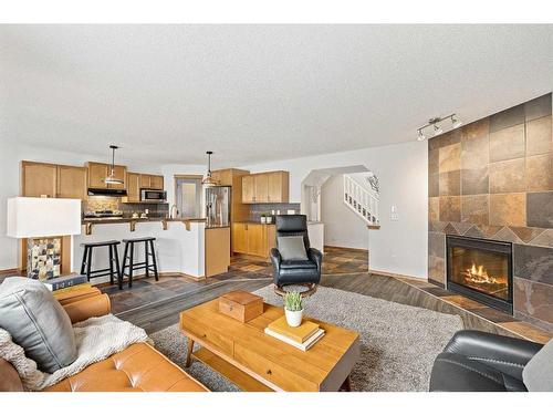 513 Coopers Drive Sw, Airdrie, AB - Indoor Photo Showing Living Room With Fireplace