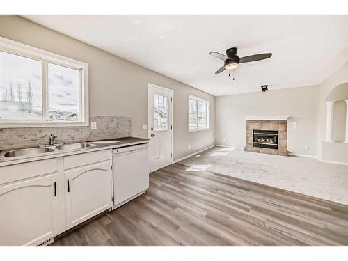 45 Cimarron Meadows Road, Okotoks, AB - Indoor Photo Showing Kitchen With Fireplace With Double Sink