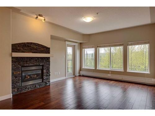 409-20 Discovery Ridge Close Sw, Calgary, AB - Indoor Photo Showing Living Room With Fireplace