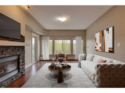 409-20 Discovery Ridge Close Sw, Calgary, AB - Indoor Photo Showing Living Room With Fireplace