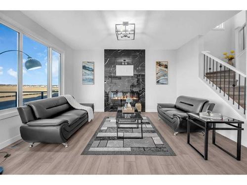 145 Amblefield Terrace Nw, Calgary, AB - Indoor Photo Showing Living Room With Fireplace