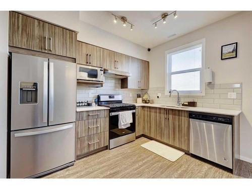203-325 Redstone Walk Ne, Calgary, AB - Indoor Photo Showing Kitchen With Stainless Steel Kitchen