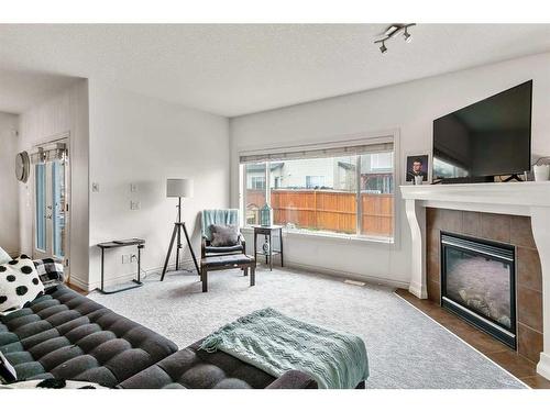 169 Bridlerange Circle Sw, Calgary, AB - Indoor Photo Showing Other Room With Fireplace