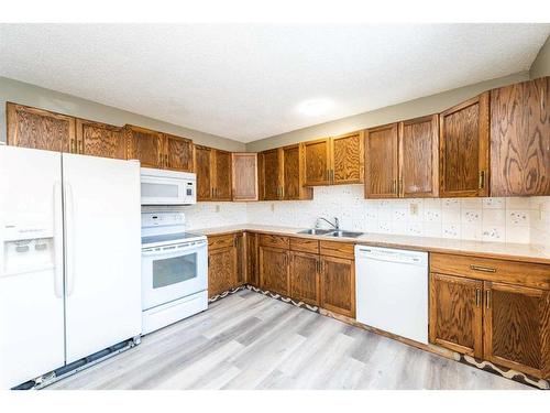 6908 15 Avenue Se, Calgary, AB - Indoor Photo Showing Kitchen With Double Sink