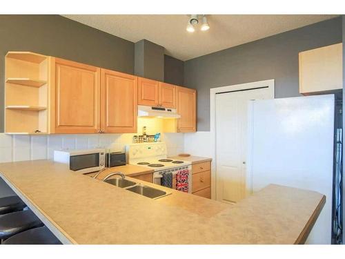2231-1010 Arbour Lake Road Nw, Calgary, AB - Indoor Photo Showing Kitchen With Double Sink