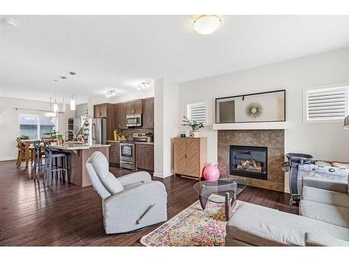 27 Belgian Link, Cochrane, AB - Indoor Photo Showing Living Room With Fireplace