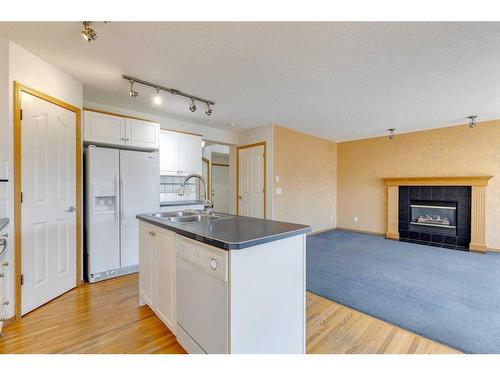 92 Mt Aberdeen Circle Se, Calgary, AB - Indoor Photo Showing Kitchen With Fireplace With Double Sink