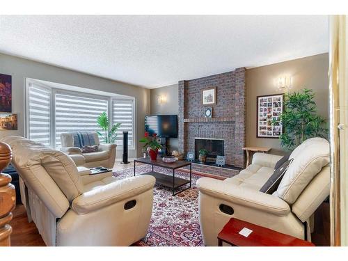 28 Templeridge Close Ne, Calgary, AB - Indoor Photo Showing Living Room With Fireplace