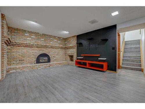119 Rundlecairn Road Ne, Calgary, AB - Indoor Photo Showing Other Room With Fireplace