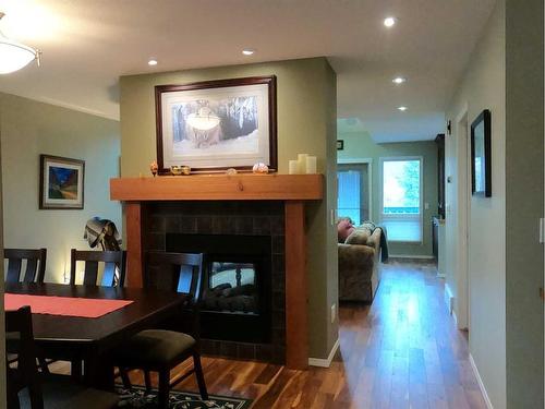 1000       #3 Cougar Creek Drive Drive, Canmore, AB - Indoor With Fireplace