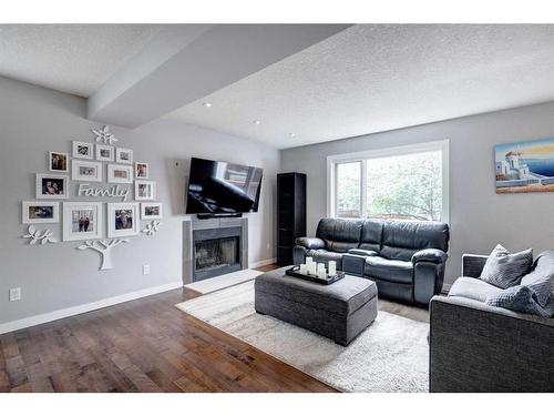70 Riverwood Crescent Se, Calgary, AB - Indoor Photo Showing Living Room With Fireplace