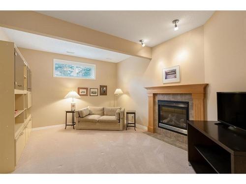 39 West Jensen Place Sw, Calgary, AB - Indoor Photo Showing Living Room With Fireplace