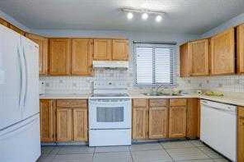 59 Whitehaven Road Ne, Calgary, AB - Indoor Photo Showing Kitchen With Double Sink