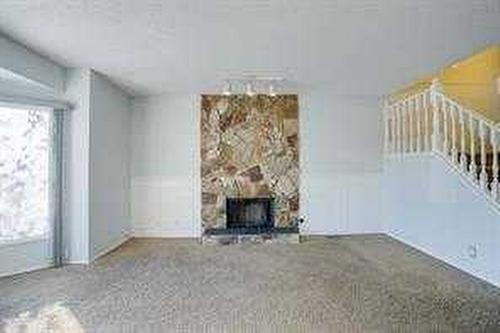59 Whitehaven Road Ne, Calgary, AB - Indoor With Fireplace