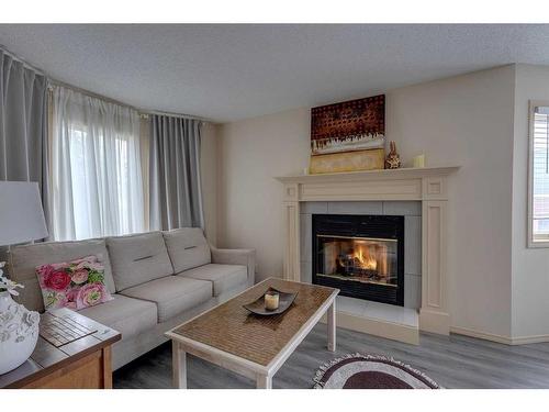 27 Abbeydale Villas Ne, Calgary, AB - Indoor Photo Showing Living Room With Fireplace