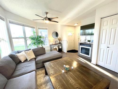 601 Prairie Sound Circle Nw, High River, AB - Indoor Photo Showing Living Room With Fireplace