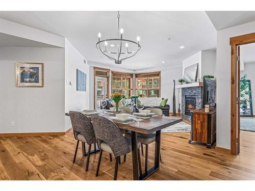 103-1105 Spring Creek Drive, Canmore, AB - Indoor Photo Showing Dining Room With Fireplace