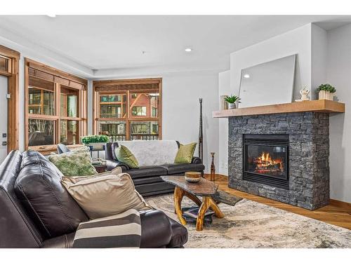 103-1105 Spring Creek Drive, Canmore, AB - Indoor Photo Showing Living Room With Fireplace