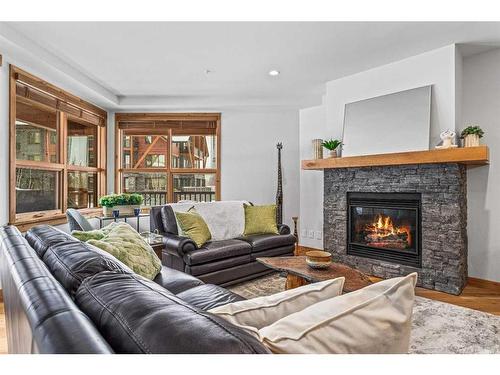 103-1105 Spring Creek Drive, Canmore, AB - Indoor Photo Showing Living Room With Fireplace