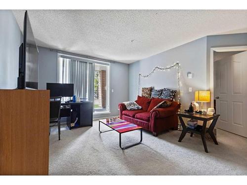 2117-10 Prestwick Bay Se, Calgary, AB - Indoor Photo Showing Living Room