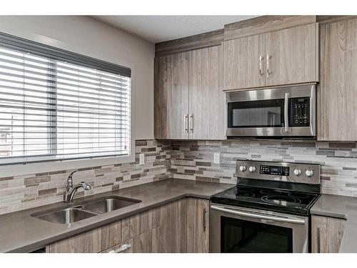 318 Legacy Village Way Se, Calgary, AB - Indoor Photo Showing Kitchen With Stainless Steel Kitchen With Double Sink