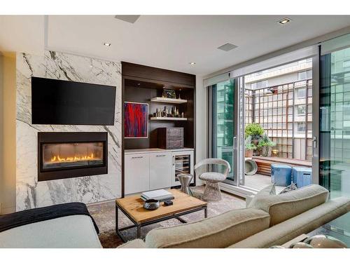 310-135 26 Avenue Sw, Calgary, AB - Indoor Photo Showing Living Room With Fireplace