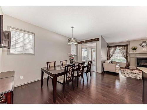 151 Everbrook Drive Sw, Calgary, AB - Indoor Photo Showing Dining Room With Fireplace