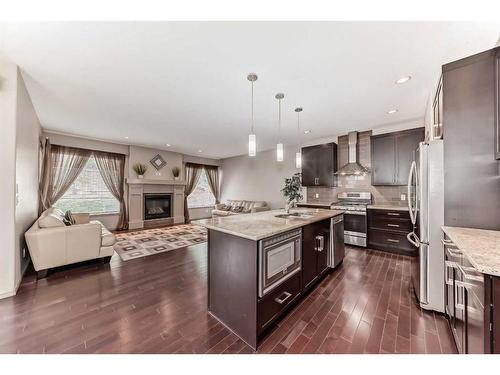 151 Everbrook Drive Sw, Calgary, AB - Indoor Photo Showing Kitchen With Fireplace With Upgraded Kitchen