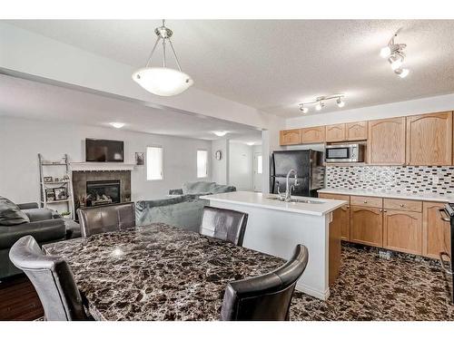42 Evansford Grove Nw, Calgary, AB - Indoor Photo Showing Kitchen With Fireplace With Double Sink