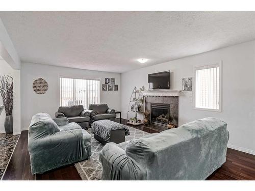 42 Evansford Grove Nw, Calgary, AB - Indoor Photo Showing Living Room With Fireplace