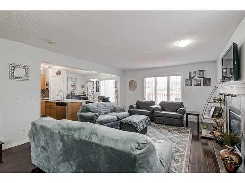 42 Evansford Grove Nw, Calgary, AB - Indoor Photo Showing Living Room With Fireplace