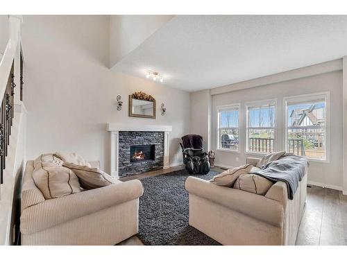 331 Reunion Green Nw, Airdrie, AB - Indoor Photo Showing Living Room With Fireplace