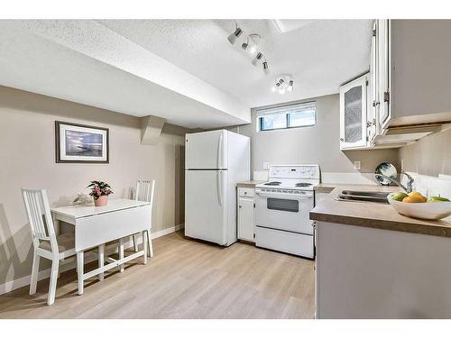 115 Deer Lane Close Se, Calgary, AB - Indoor Photo Showing Kitchen With Double Sink
