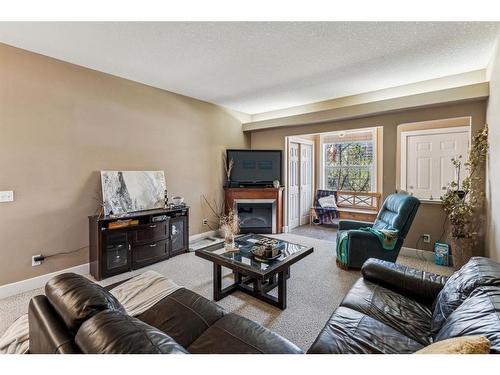 23-27 Springborough Boulevard Sw, Calgary, AB - Indoor Photo Showing Living Room With Fireplace